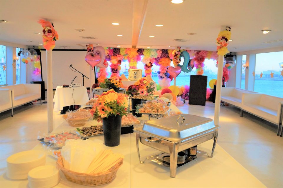 Inside the boat * with buffet dishes on the buffet table and gorgeously decorated with balloons and flowers