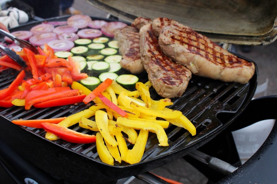 Steak grilled on the BBQ grill and colorful vegetables.